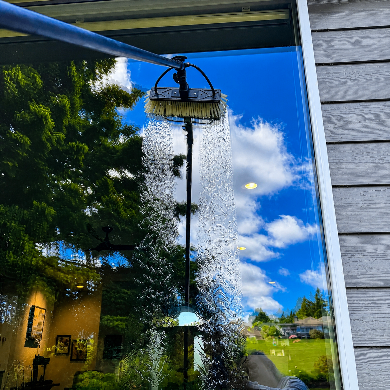 Filtered water sheeting down a spotless exterior window