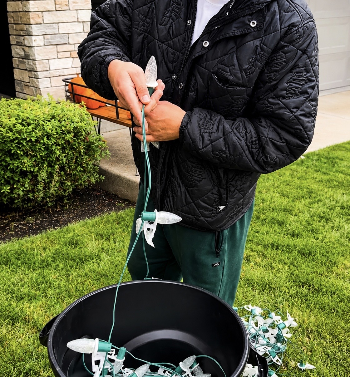 Close-up of a Halen Homes installer prepping commercial warm-white C9 bulbs